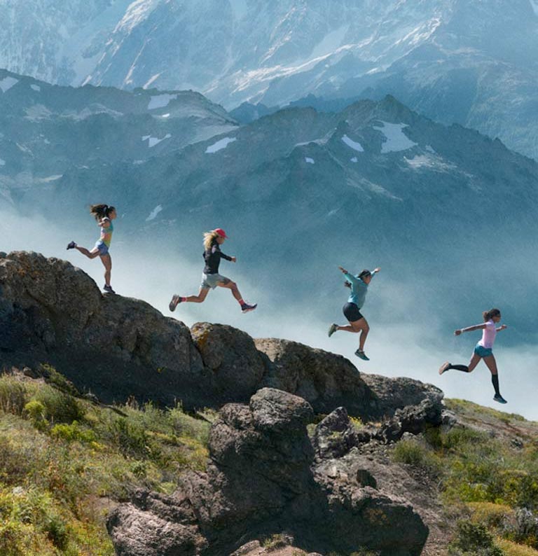 People running down a mountain side.