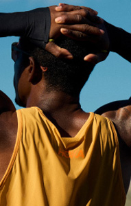 Man wearing HOKA gear looking at mountains.