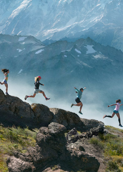 People running down a mountain side.