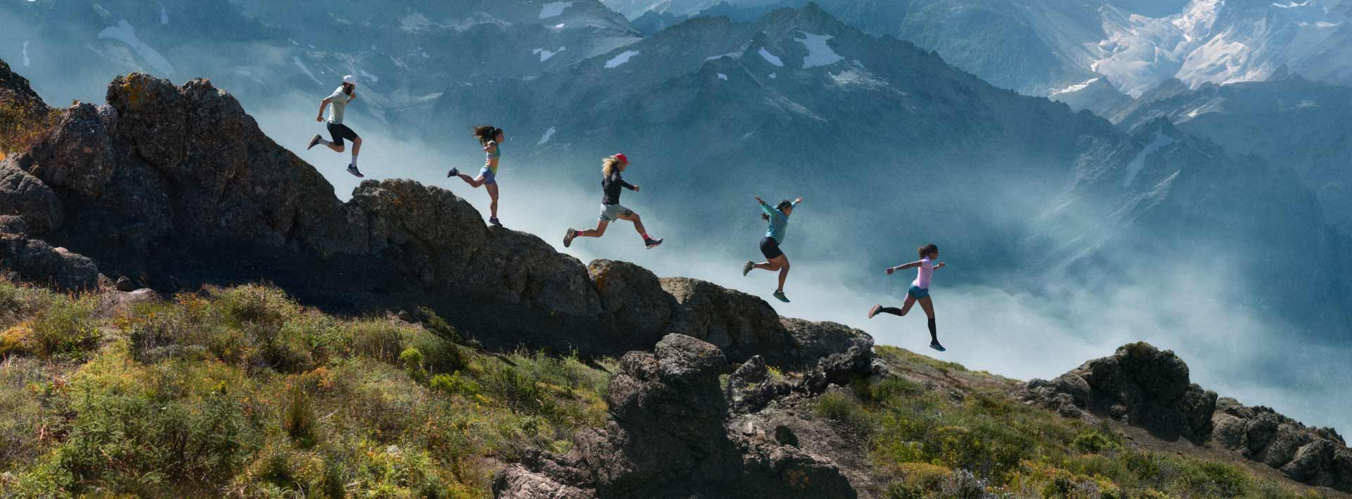 People running down a mountain side.